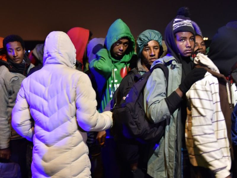 Migrants queue for transportation by bus to reception centres across France, from the "Jungle" migrant camp in Calais, northern France, on October 24, 2016. (AFP/Philippe Huguen)