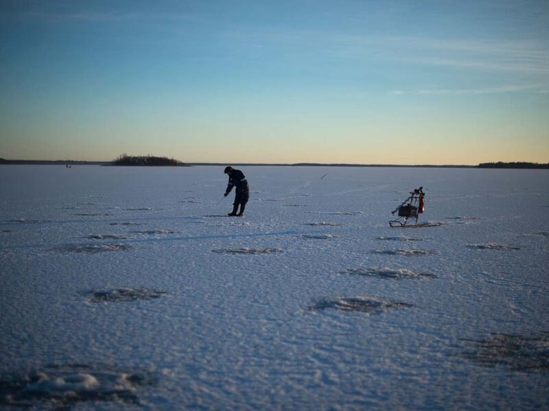 An aerial view of fishing holes bored into the frozen sea on the Gulf of Bothnia, near Vaasa, Western Finland on December 28, 2018, where winter daylight last for some four hours. 
Olivier MORIN / AFP