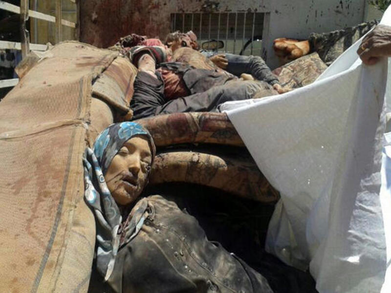 Bodies are seen in the back of a pick-up truck as it arrives in the eastern Lebanese city of Baalbek. The bodies of six Syrians killed near the border with Lebanon were transported into the country along with nine injured people, a Lebanese military source told AFP (AFP/STR)