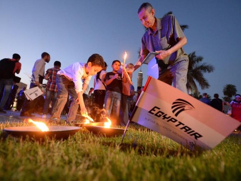 Egyptians gather at a candle light vigil for the victims of the EgyptAir plane crash that killed all 66 people on board when it went down in the Mediterranean. 