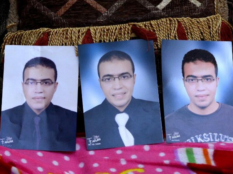 A picture taken on February 5, 2017, shows portraits of Abdallah El-Hamahmy, an Egyptian suspected of being the machete attacker in Paris's Louvre museum, placed on a sofa at the family home in the Nile delta city of Mansura, some 120 kms north of Cairo. (AFP/Mahmood Shahin)