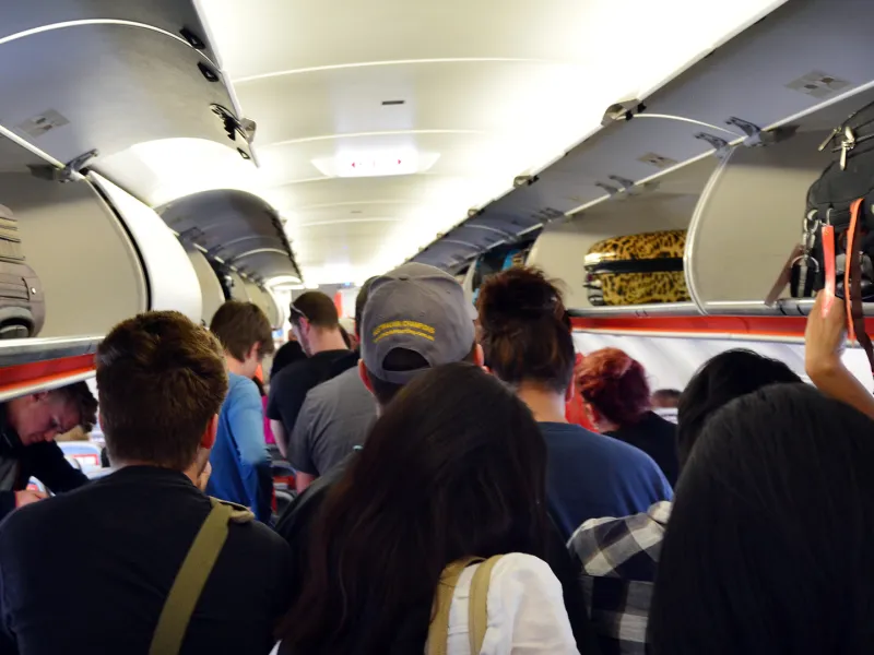 passengers standing in aisle airplane
