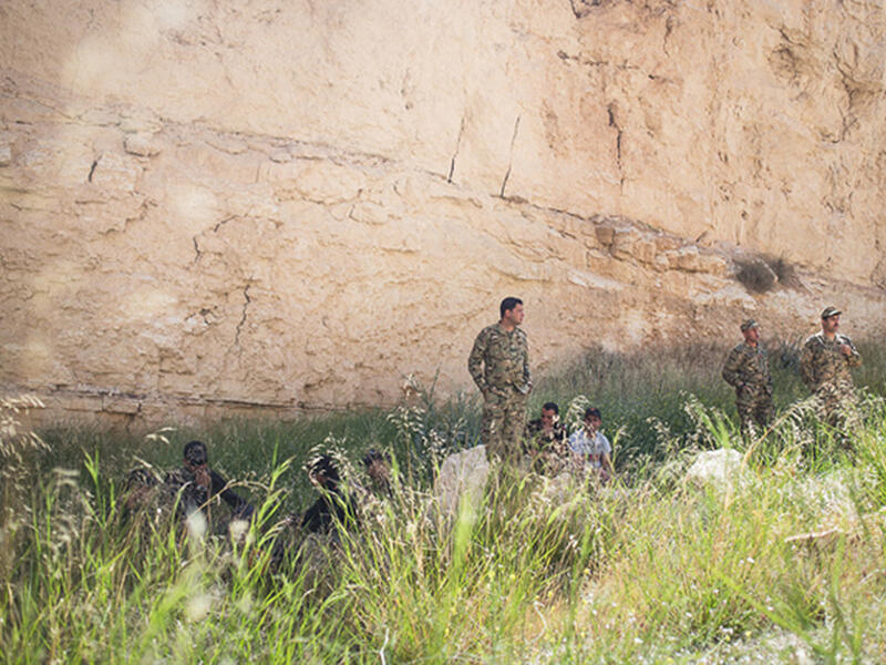 Jordan's team rests in the shade of a sandstone cliff before the Warrior Competition "urban assault" event where soldiers rush over a dirt verge, storm a building in a mock city, and rescue a hostage. Jordan's special forces have joined the ongoing fight against Daesh, when a militant cell was uncovered in northern city, Irbid.