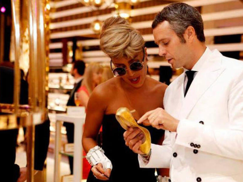 Maya Diab inspecting her gold-plated shoe (Image: Facebook)