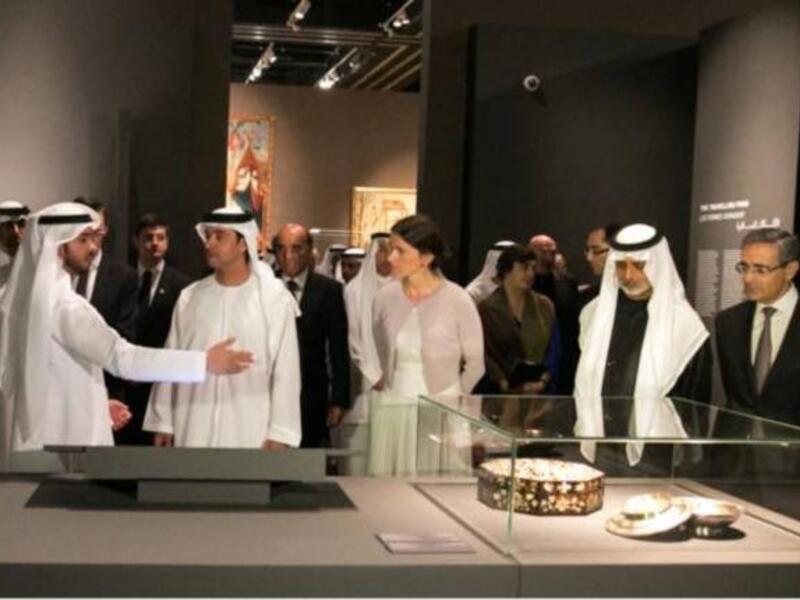 Shaikh Hazza Bin Zayed and other guests look at some of the Louvre's permanent pieces during the 'Birth of a Museum' exhibition.