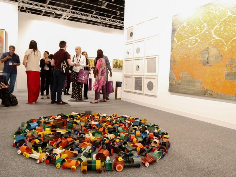 Visitors at Abu Dhabi Art 2016; a floor piece by Hussain Sharif (foreground). (Gulf News)
