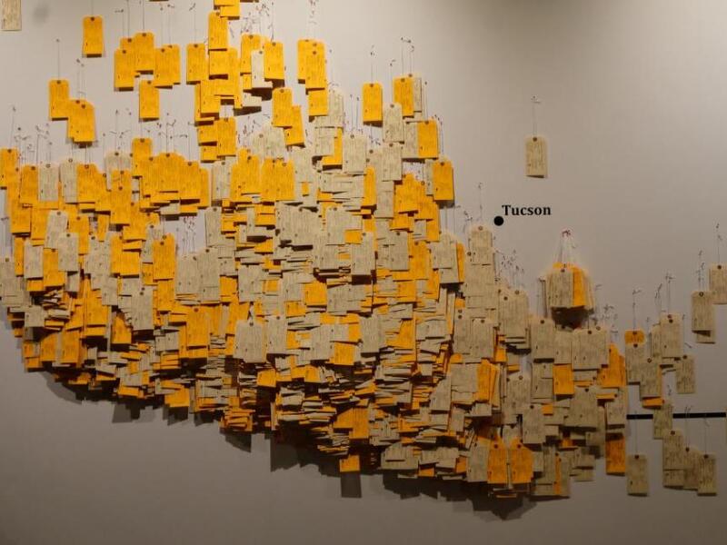 A new exhibit uses toe tags with the names of dead migrants found at the Arizona-Mexico border from 1994 as a graphic reminder that crossing borders claims lives. (Photo courtesy of "Hostile Terrain 94.")