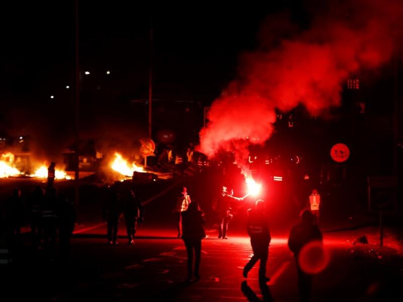 People block Caen's circular road on November 18, 2018 in Caen, northwestern France, on a second day of action after a nationwide popular initiated day of protest called "yellow vest" movement against high fuel prices.
CHARLY TRIBALLEAU / AFP