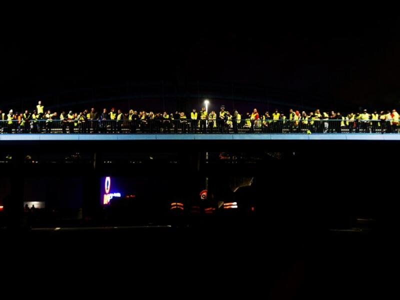 People stand in a bridge as they block the Caen's circular road on November 18, 2018 in Caen.
CHARLY TRIBALLEAU / AFP