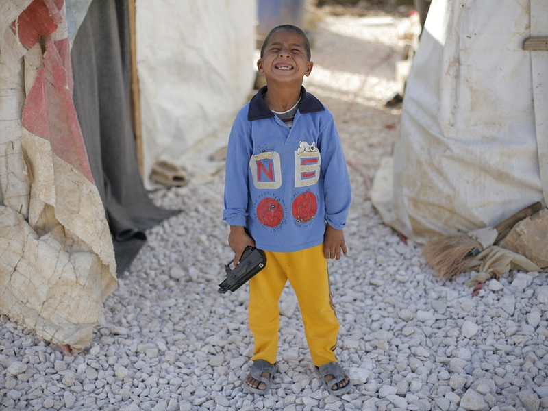 A boy plays with his toy gun at a Syrian refugee camp in Lebanon's Bekaa Valley.  (AFP/Matthieu Alexandre)