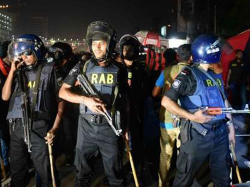 Bangladesh police inspect the crime scene as an attacker was killed in front of a police box at the entrance to Dhaka’s international airport on March 24, 2017. (AFP)