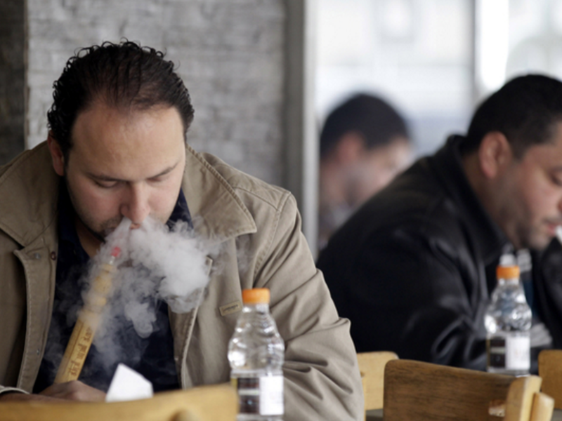 Men smoke sheesha at an Amman cafe in February 2014. (photo credit: AFP/Khalil Mazraawi)