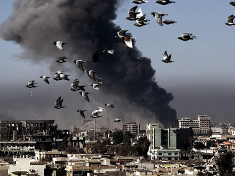 Smoke rises following an airstrike in western Mosul on March 6, 2017, during an offensive by Iraqi forces to retake the western parts of the city from Islamic State (IS) group.(AFP/Aris Messinis)