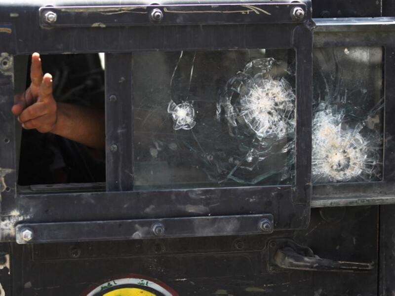A member of the Iraqi Counter-Terrorism Service (CTS) flashes the victory sign from the window of a humvee during an advance in the old city of Mosul on July 5, 2017, as the Iraqi government forces continue their offensive to retake the city from Islamic State (IS) group fighters. (Ahmad al-Rubaye/AFP)