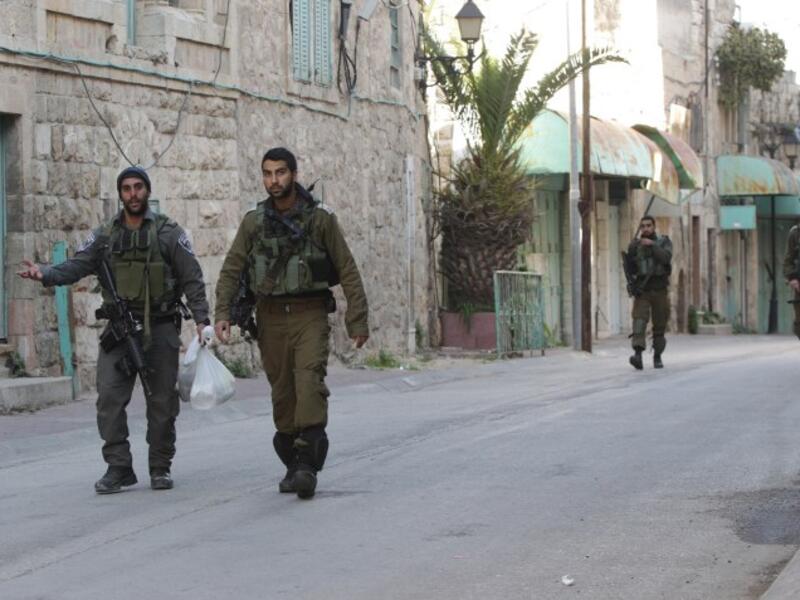 Israeli forces walk through the streets of Hebron, in the West Bank. (AFP/Hazem Bader)
