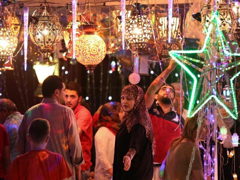 Jordanians shop for traditional lanterns known in Arabic as "Fanous", sold during the Muslim holy month of Ramadan, at a market in the capital Amman on 5 June, 2016, as the the fasting month begins. (AFP/Khalil Mazraawi)