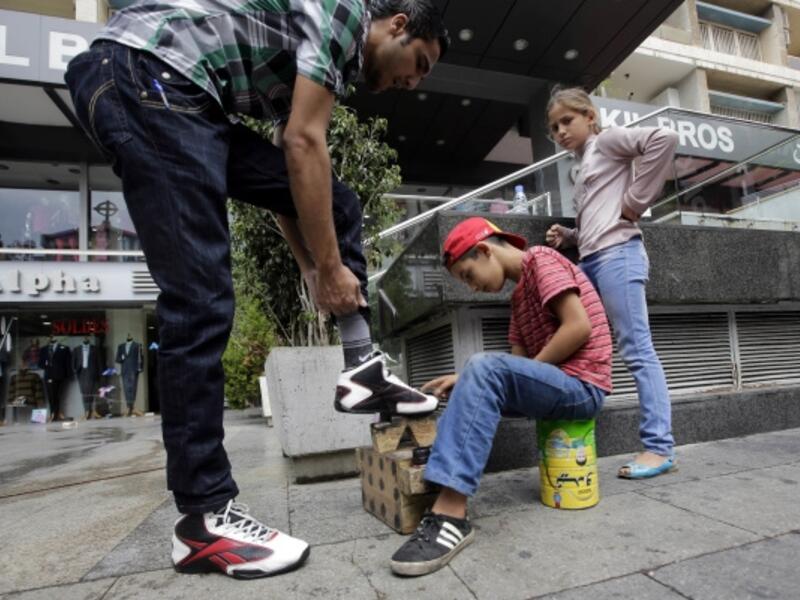 A Syrian child works as a shoe shine in Beirut. (AFP/file)