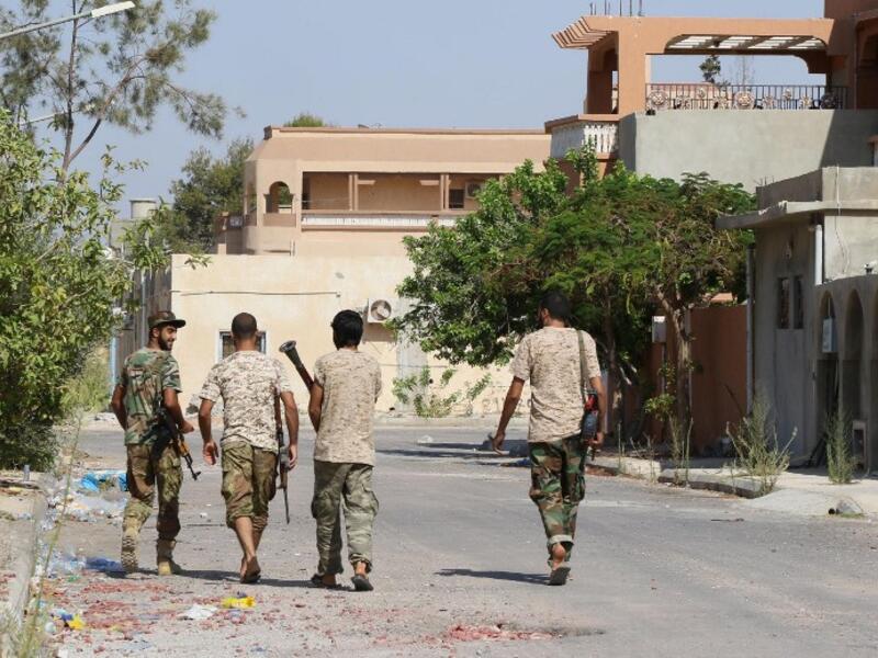 Government of National Accord forces walk through Sirte, Libya. (AFP/Mahmud Turkia)