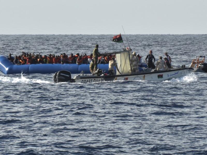 This file photo taken on November 04, 2016 shows migrants and refugees on a rubber boat as the Libyan coastguards patrol on November 4, 2016 off the Libyan coast. (Andreas Solaro/AFP)