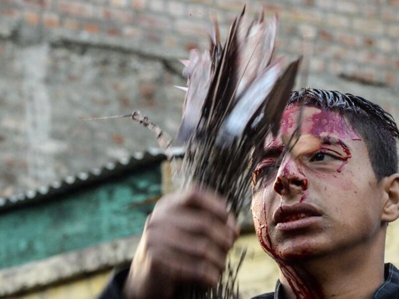 A Kashmiri Shiite Muslim mourner flagellates himself during a religious procession held on the seventh day of Ashura which remembers the slaying of the Prophet Muhammed's grandson in southern Iraq in the seventh century, in Srinagar on September 18, 2018. TAUSEEF MUSTAFA / AFP