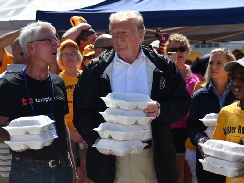 US President Donald Trump greets residents with prepared meals September 19, 2018 in New Bern, North Carolina as he tours areas of the eastern state pummeled by Hurricane Florence. 
Nicholas Kamm / AFP