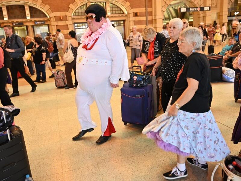 Elvis fans dance to Elvis songs at Central station before boarding a train to to The Parkes Elvis Festival, in Sydney on January 10, 2019. 
PETER PARKS / AFP