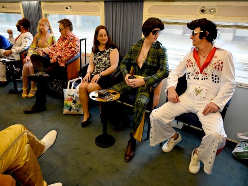 Elvis fans sit on a train after leaving Central station to head to The Parkes Elvis Festival, in Sydney on January 10, 2019. The Parkes Elvis Festival is an annual event celebrating the music and life of Elvis Presley in the New South Wales town of Parkes.
PETER PARKS / AFP