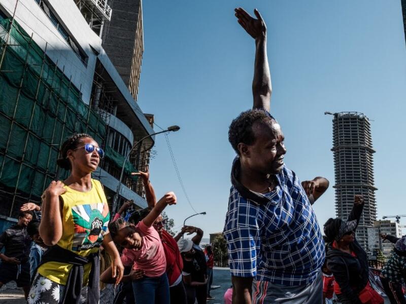 People take part in an exercise on a street in Addis Ababa on February 3, 2019 during the third Car Free Day promoted by local NGOs and the Ethiopian Government to appeal to a healthy life style and a less air pollution of the capital city. 
EDUARDO SOTERAS / AFP