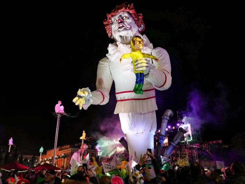 A carnival float with a giant statue of US President Donald Trump depicted as an evil clown holding a French President Emmanuel Macron's puppet in his hand parade on the first day of the 135th Nice Carnival.
VALERY HACHE / AFP