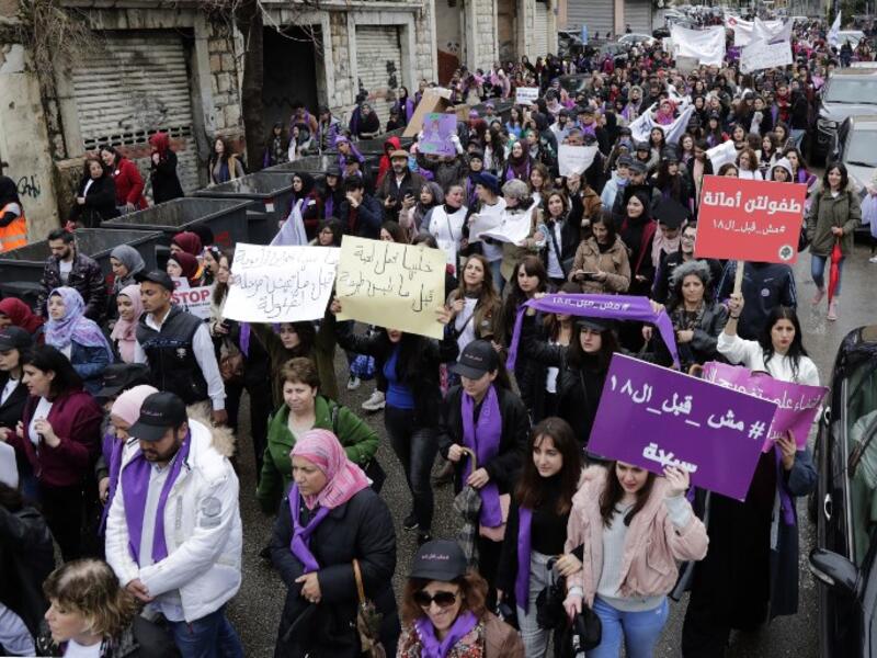 Lebanese demonstrators hold placards as they participate in a march against marriage before the age of 18 in the capital Beirut, on March 2, 2019. 
ANWAR AMRO / AFP