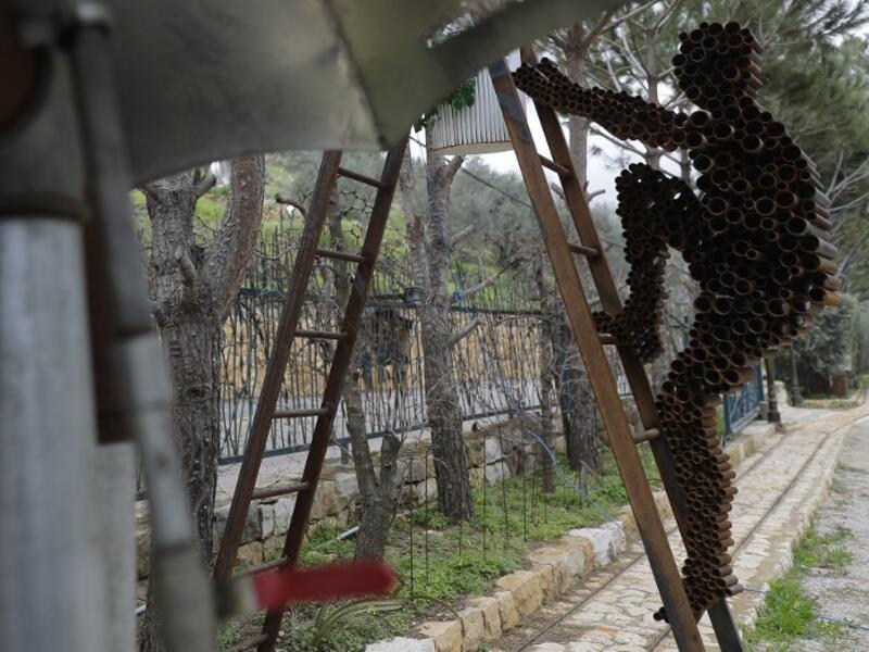 In a celebration of tradition and memory, artist Charles Nassar has been transforming the dark, wrangled remains into sculptures. "I hate shrapnel, but I also love it at the same time," said the 54-year-old sculptor with a neat salt-and-pepper beard, from a garden south of Beirut.
JOSEPH EID / AFP
