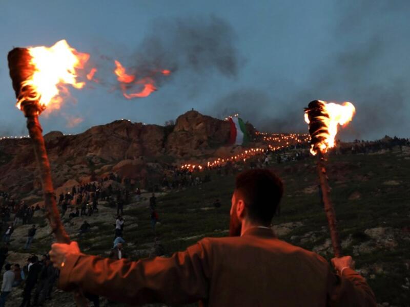An Iraqi Kurd holds lit torches in the town of Akra, 500 kilometres north of the capital Baghdad, on March 20, 2019, during celebrations of Nowruz (Noruz), the Persian New Year.
SAFIN HAMED / AFP