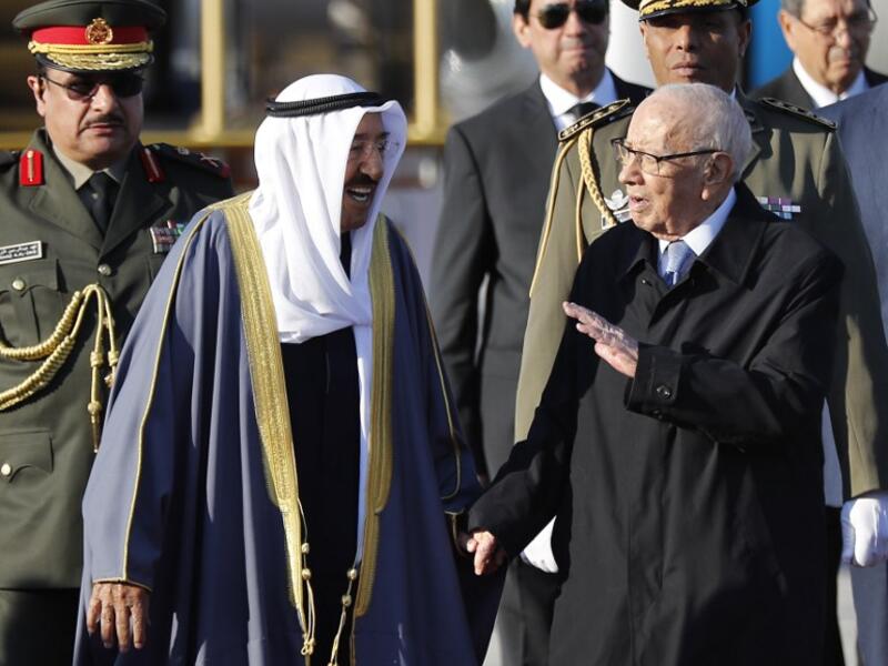 Tunisian President Beji Caid Essebsi (R) welcomes Kuwait's Emir Sheikh Sabah al-Ahmad al-Sabah upon his arrival at Tunis-Carthage international airport on March 30, 2019, to attend the Arab Summit. 
Hussein Malla / POOL / AFP