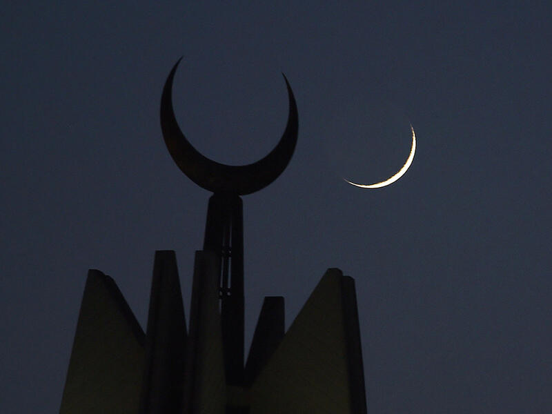 The new crescent moon of Ramadan rises over the Faisal Mosque in Islamabad, Pakistan.
 Farooq Naeem/AFP