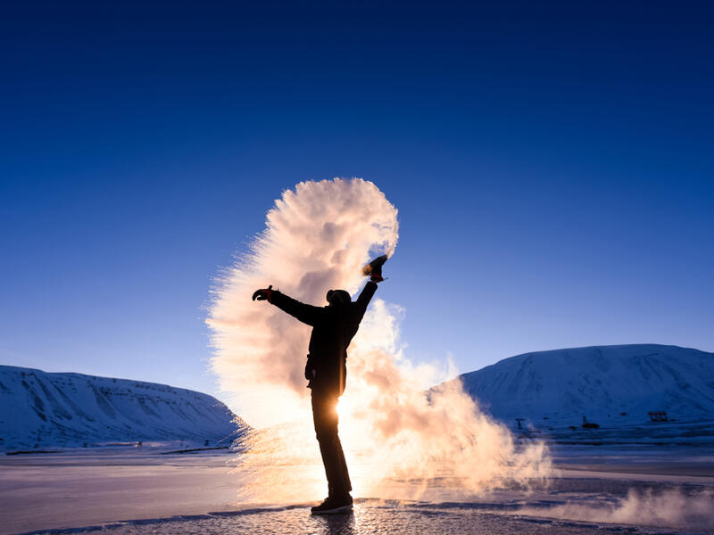 Boiling water frost in polar arctic sky in Norway Svalbard in Longyearbyen man mountains. (Shutterstock/ File Photo)