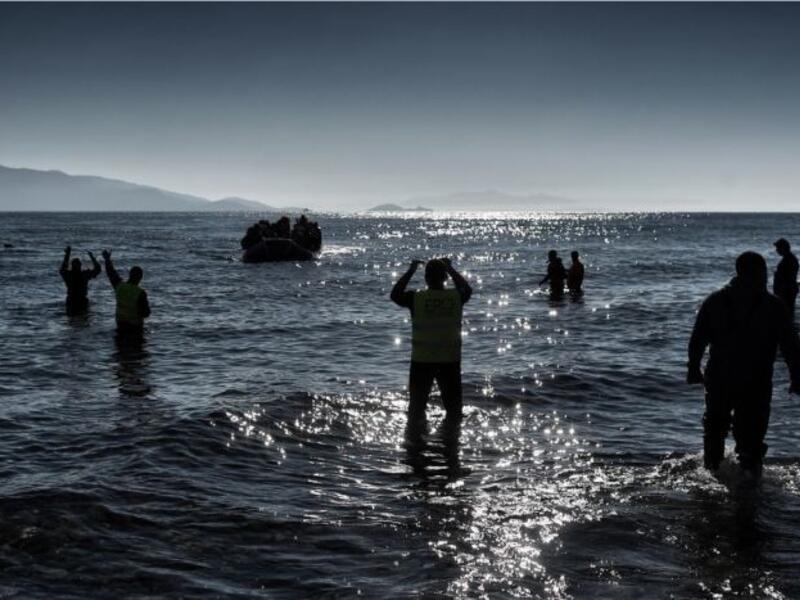 A boat carrying refugees and migrants arrives on a Greek island, after crossing the Aegean sea from Turkey in February. (AFP/Aris Messinis)