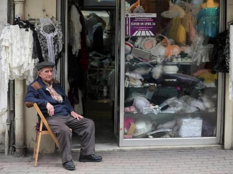 A Lebanese-Armenian man sits next to his shop in the Burj Hammoud area of Beirut. (AFP/File)