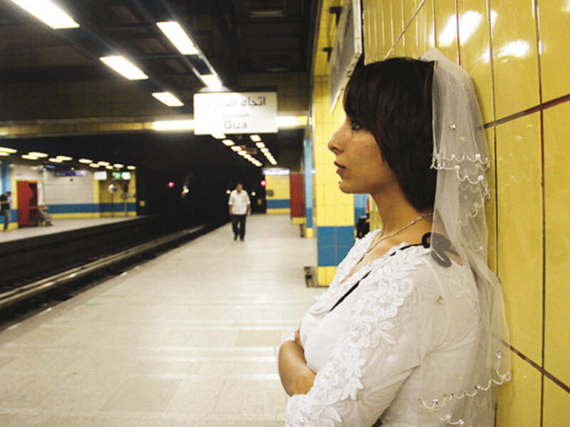 In early 2015, an unwed Egyptian woman named Samah Hamdi appeared in photos and video going through her daily routine donning a wedding gown and a veil in an attempt to ridicule communal pressure on Egyptian women to marry. (Courtesy photo)