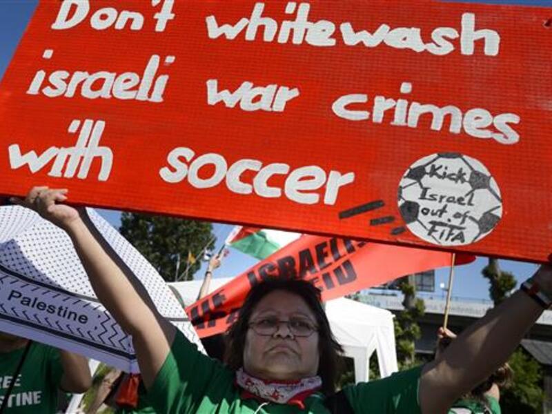 Demonstrators call for the expulsion of Israel from FIFA during a protest rally prior to the opening of the 65th FIFA Congress in Zurich, Switzerland. (AFP/File)