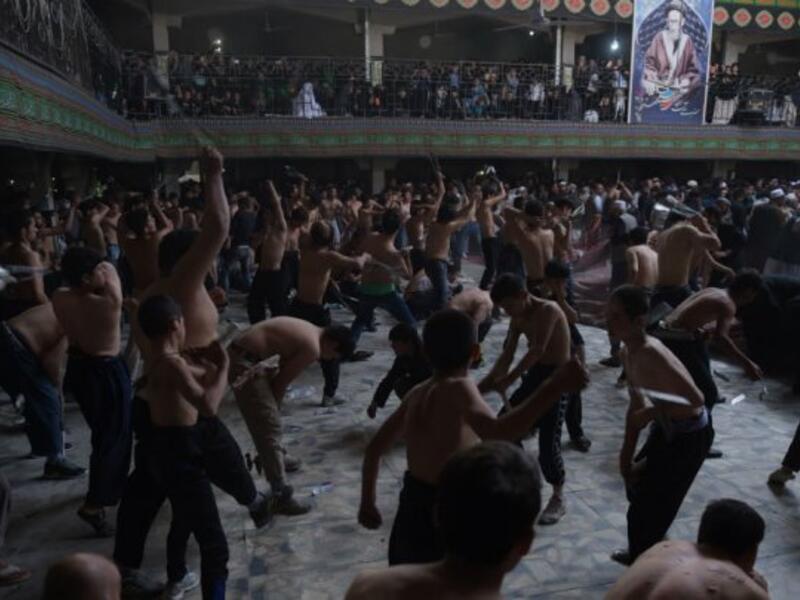 Afghan Shia Muslims conduct self-flagellation rituals as part of the Ashura commemorations at a Kabul mosque on October 9, 2016. (AFP/Shah Marai)