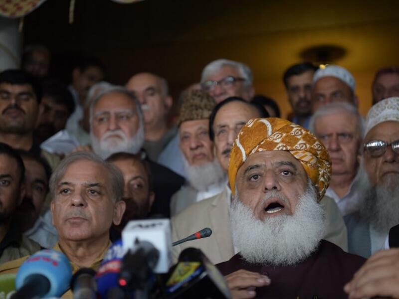 Shahbaz Sharif (R), younger brother of ousted Pakistani Prime Minister Nawaz Sharif and head of Pakistan Muslim League-Nawaz (PML-N), arrive with opposition leader Maulana Fazalur Rehman (L) for a press conference after attending an All Parties Conference in Islamabad on July 27, 2018. (AFP/Aamir Qureshi)
