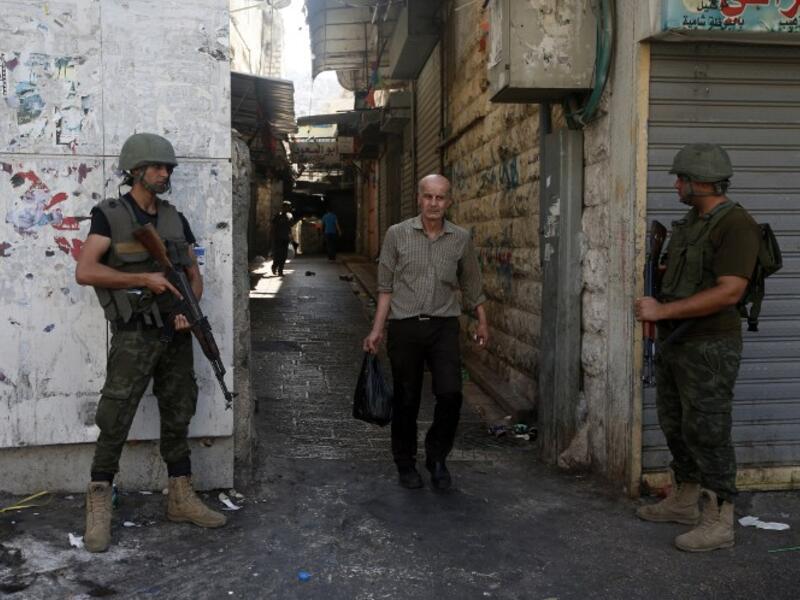 Palestinian security forces stand guard in the West Bank city of Nablus after clashes in August 2016. (AFP/file)
