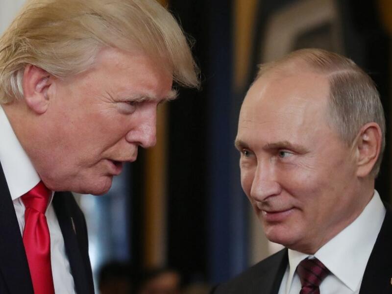 US President Donald Trump chats with Russia's President Vladimir Putin as they attend the APEC Economic Leaders' Meeting (Mikhail Klimentyev/AFP)