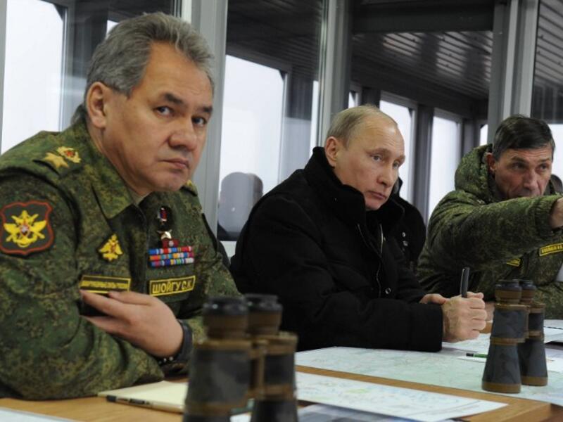 President Putin with Defence Minister Sergei Shoigu watching military exercises at the Kirillovsky firing ground in the Leningrad region, on March 3, 2014.(AFP PHOTO/ RIA-NOVOSTI/ POOL/ MIKHAIL KLIMENTYEV)