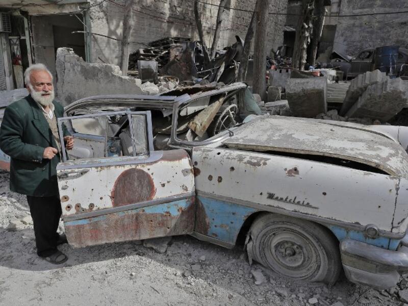 Mohammed inspects his 1957 Mercury Montclair outside his home in Aleppo. When asked “how can you live here?” he replied simply, “this is my home.”