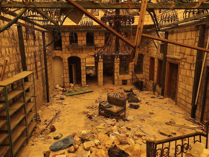 The interior of a damaged building is seen during a sandstorm in Aleppo, Syria. Following a long government siege, the city has barely an hour of electricity a day with generators operating here and there. 