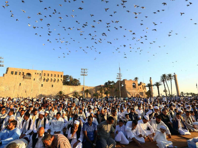 Muslim worshippers perform Eid el-Fitr prayers at the Martyrs' Square in the Libyan capital Tripoli on June 25, 2017. Since the toppling of Muamar Gaddafi in 2011, the country remains trapped in a civil war. Since 2014, fighting mostly occurs between the two rival governments, the House of Representatives and General National Congress.