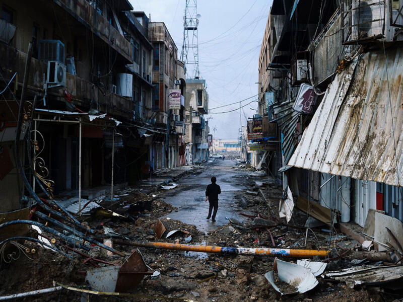 An Iraqi boy walks down a street near Mosul's University on January 22, 2017. The fight for Mosul has left six districts almost completely destroyed. Many displaced people cannot return home because their houses and livelihoods are gone. In addition, remaining mines and explosive remnants make a safe return difficult.
