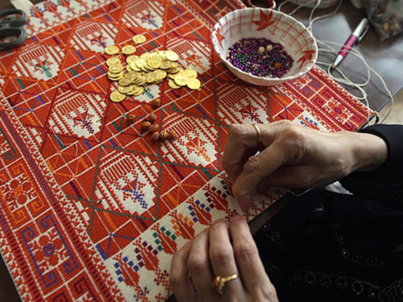 This 48-year-old Palestinian woman supports her family through home-based embroidery business while keeping the tradition alive. "By doing this work, which is part of our Palestinian heritage, I feel that women can renew our heritage and save it from extinction." (AFP)