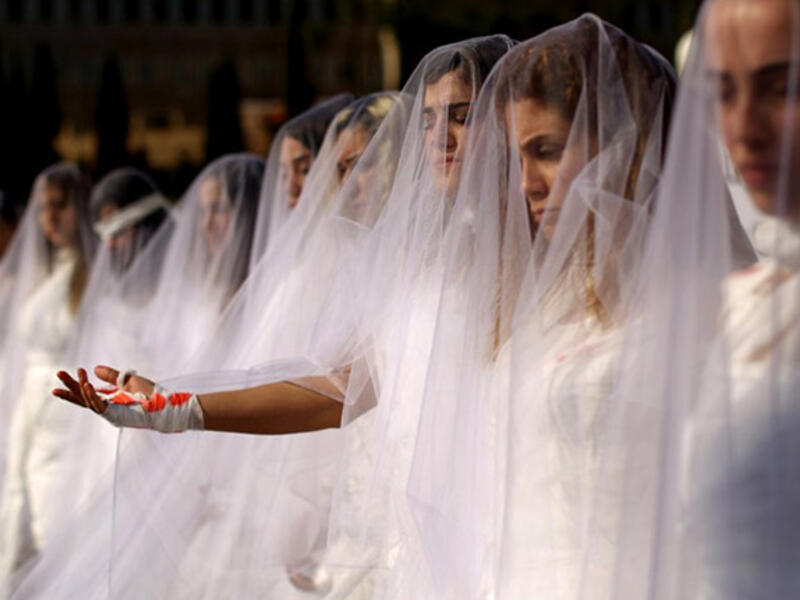 Scrapping laws that protect rapists: Activists from the Lebanese NGO Abaad (Dimensions), a resource center for gender equality, dressed as brides and wearing bandages hold a protest in downtown Beirut on December 6, 2016, against article 522 in the Lebanese penal code. 